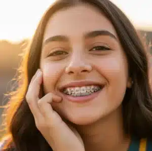 Smiling young person with braces showing confident, pain-free smile