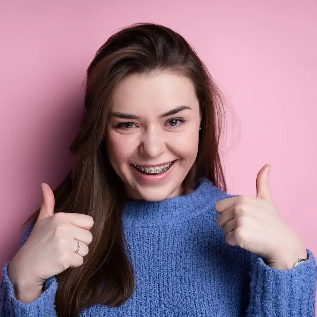 Patient smiling with clear ceramic braces in Bronx NY